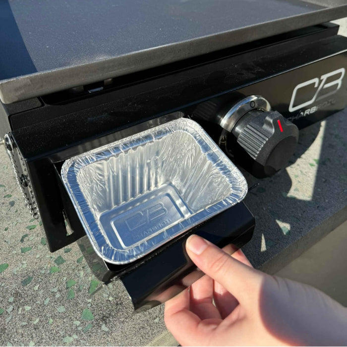 Black Char-Broil portable grill with aluminum baking pan.