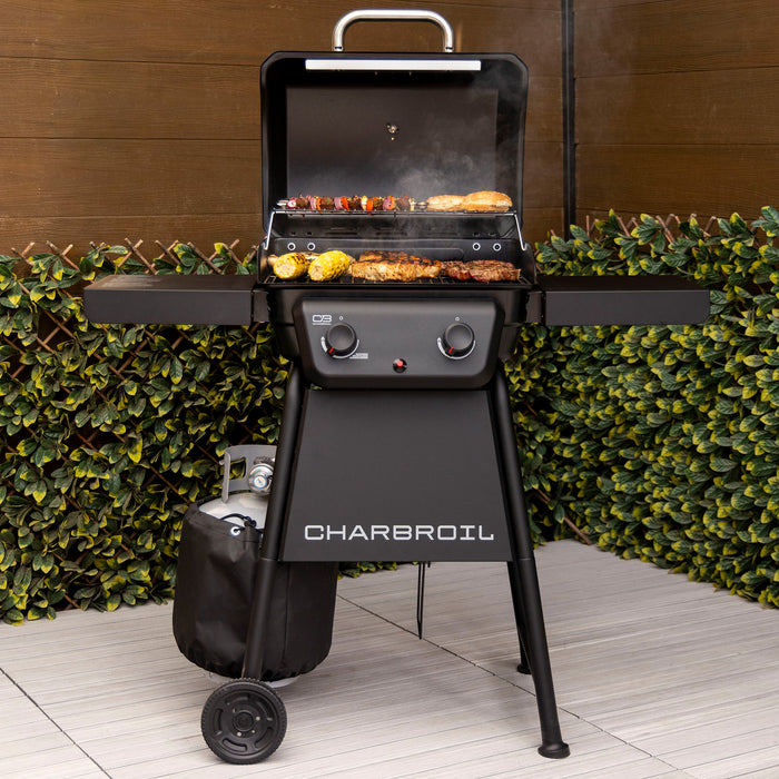Black Char-Broil electric grill with food cooking on the grill.