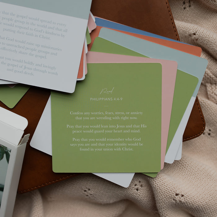The backs of the 31 Days of Prayer cards on a leather bible on a cream colored cloth