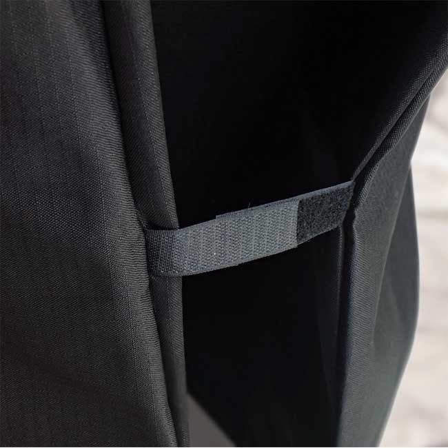 Black backpack with adjustable gray strap detail.
