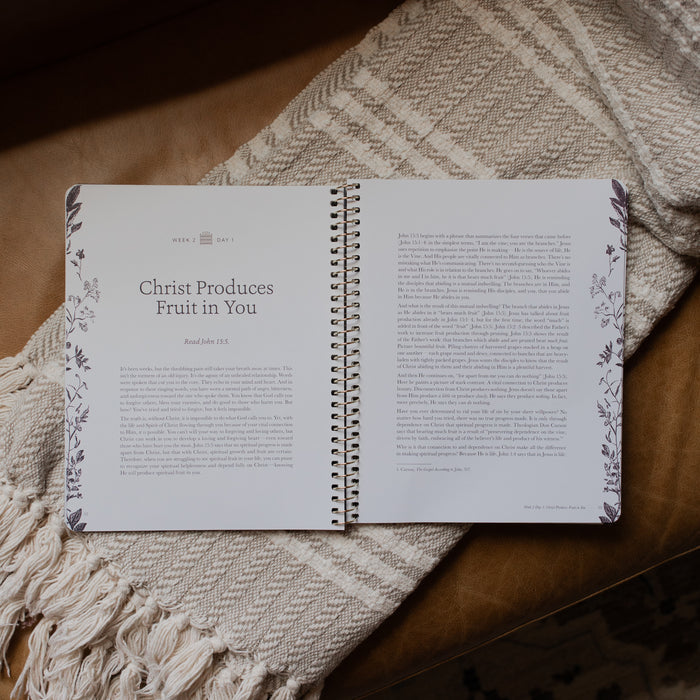 The Abide Spiral opened to the Week 2 Day 1 Reading page on a cream colored blanket