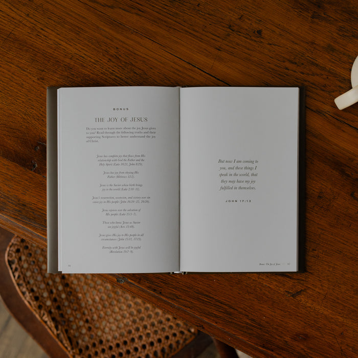 The Abide Hardcover opened to the Bonus page on a wooden table