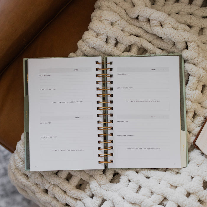 Abide Journal Refresh opened to the notes section on a white knitted blanket on a leather couch