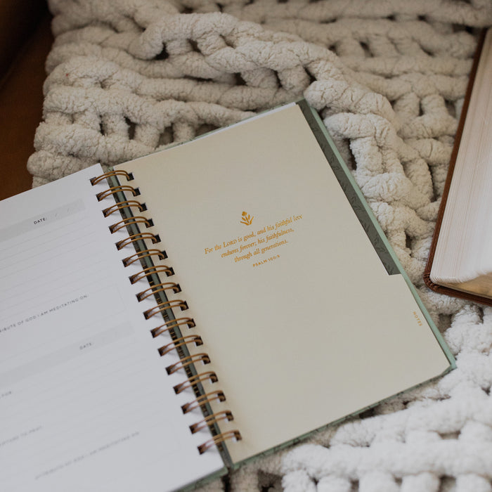 Abide Journal Refresh opened to the notes section up close on a white knitted blanket on a leather couch