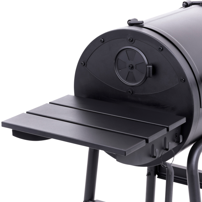 Black outdoor pizza oven with flat prep surface and vented lid.