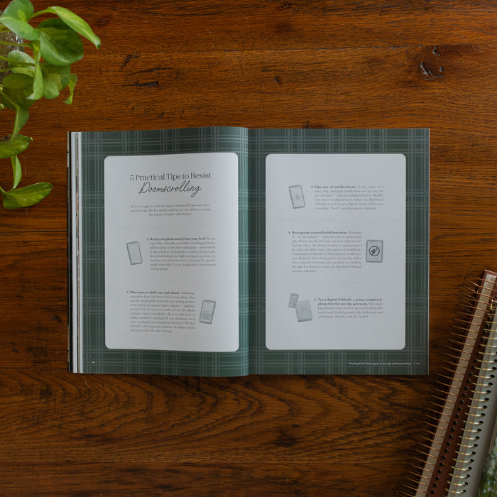 Be Still Issue 40 Magazine opened to the 5 practical tips to resist doomscrolling page on a wooden table near some greenery