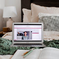 computer with digital bible course and bible on bed
