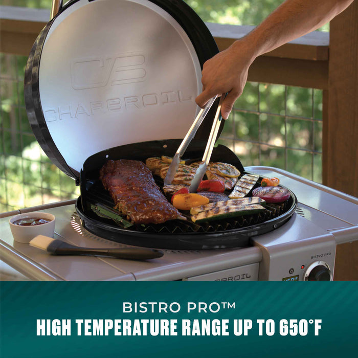Char-Broil Bistro Pro electric grill with charcoal mode, cooking assorted meats and vegetables.