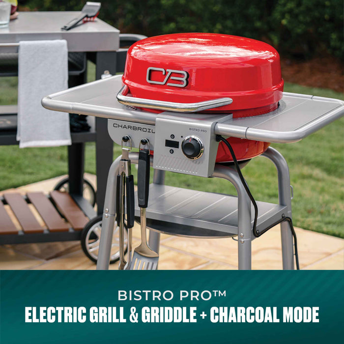 Red Char-Broil Bistro Pro electric grill with griddle and charcoal mode, silver frame, utensil hooks, outdoor use.