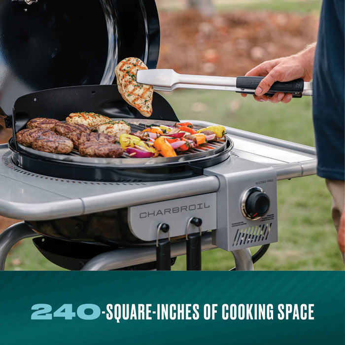 Silver Char-Broil Bistro Pro electric grill with burgers and vegetables cooking.