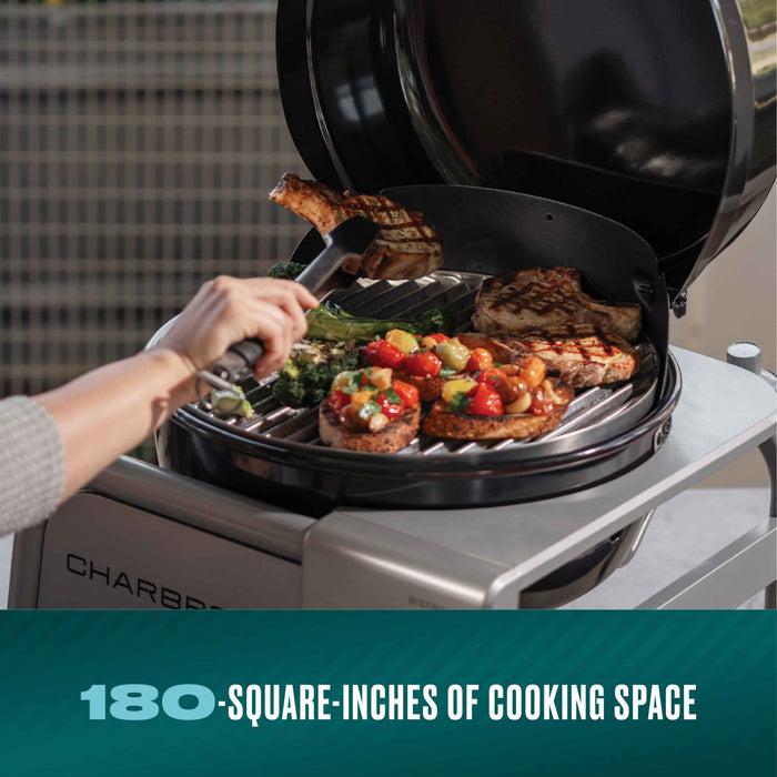 Char-Broil Bistro Pro electric grill with charcoal mode, cooking steak and vegetables.