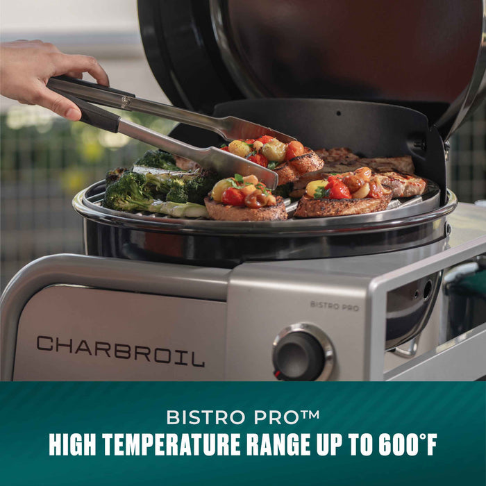 Silver Char-Broil Bistro Pro electric grill with food cooking on top.