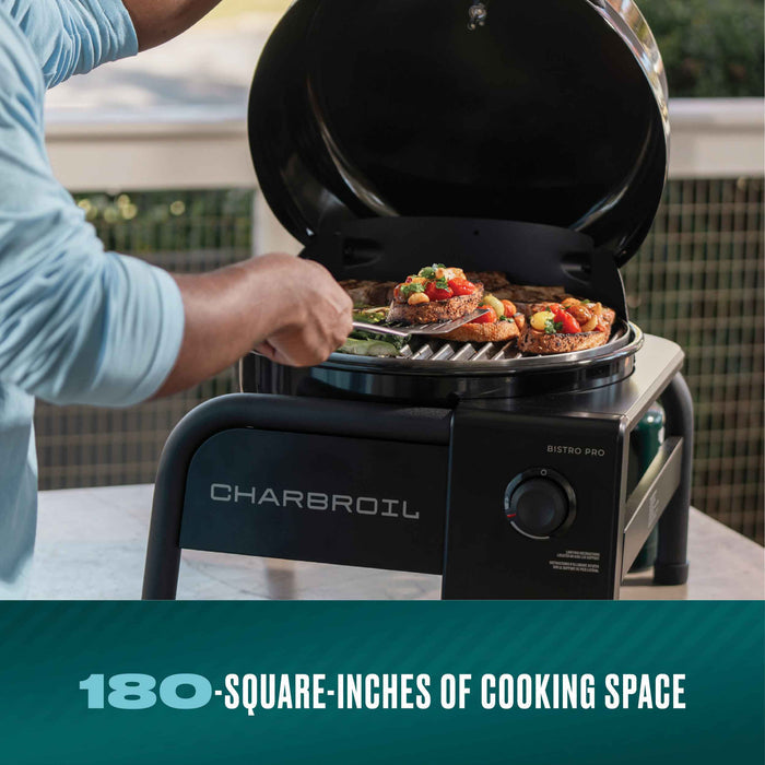 Black Char-Broil Bistro Pro electric grill with food cooking on it.