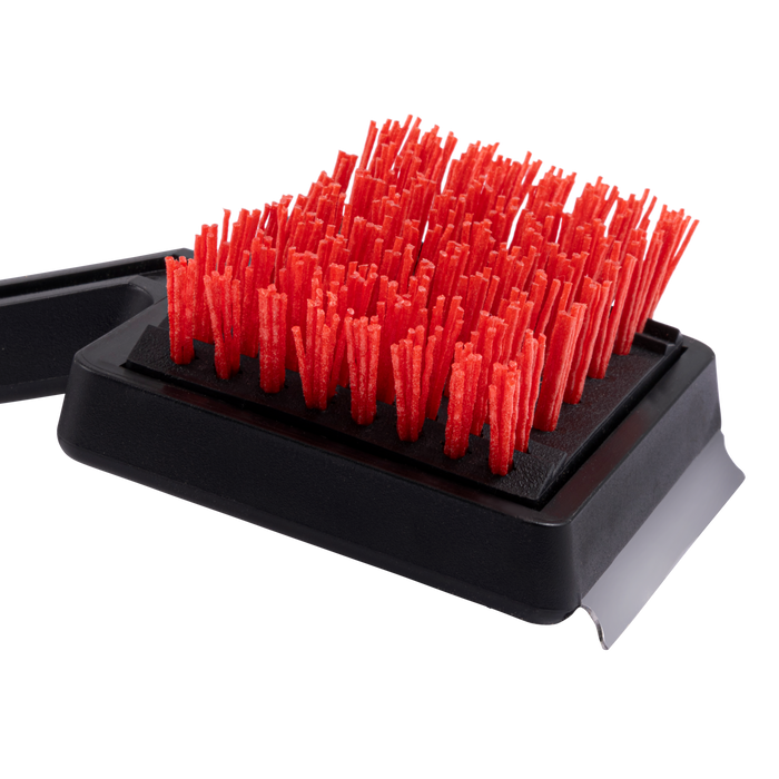 Red bristle brush on black base, angled view.