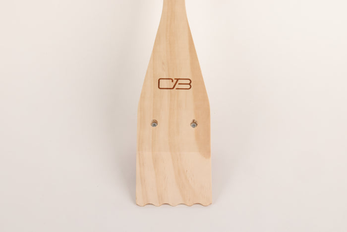 Light wooden spatula with "CB" logo, featuring two screws on handle.