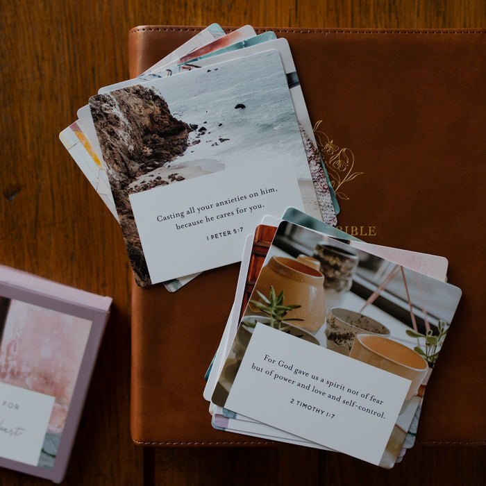 Two stacks of the Comfort for the Anxious Heart Verse Cards stacked on a leather bible