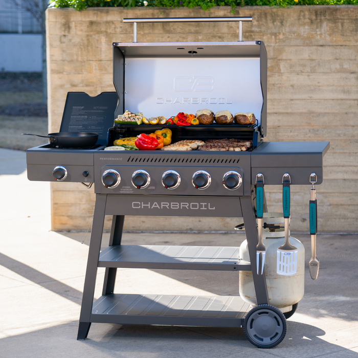 Gray Char-Broil Performance gas grill with side burner and accessories.