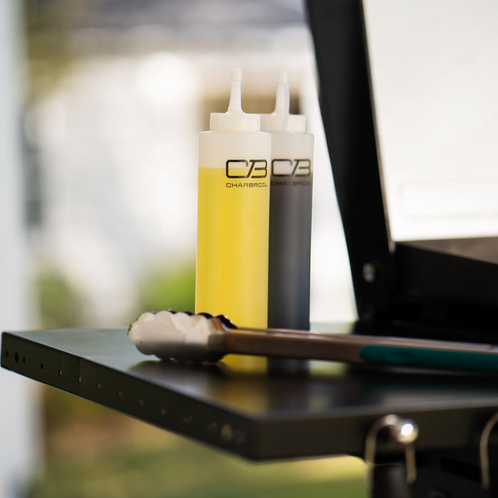 Yellow Char-Broil squeeze bottle with black lid and nozzle.
