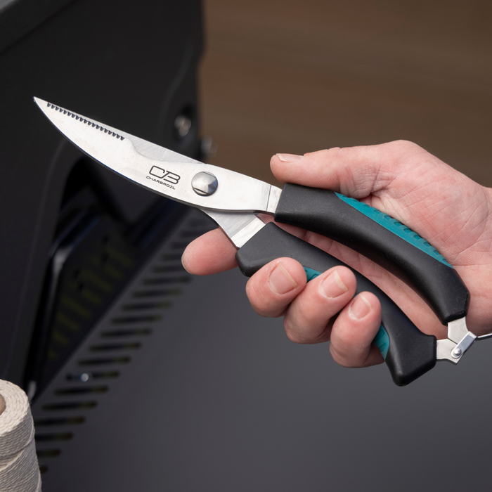 Black-handled Char-Broil kitchen shears with teal accents.