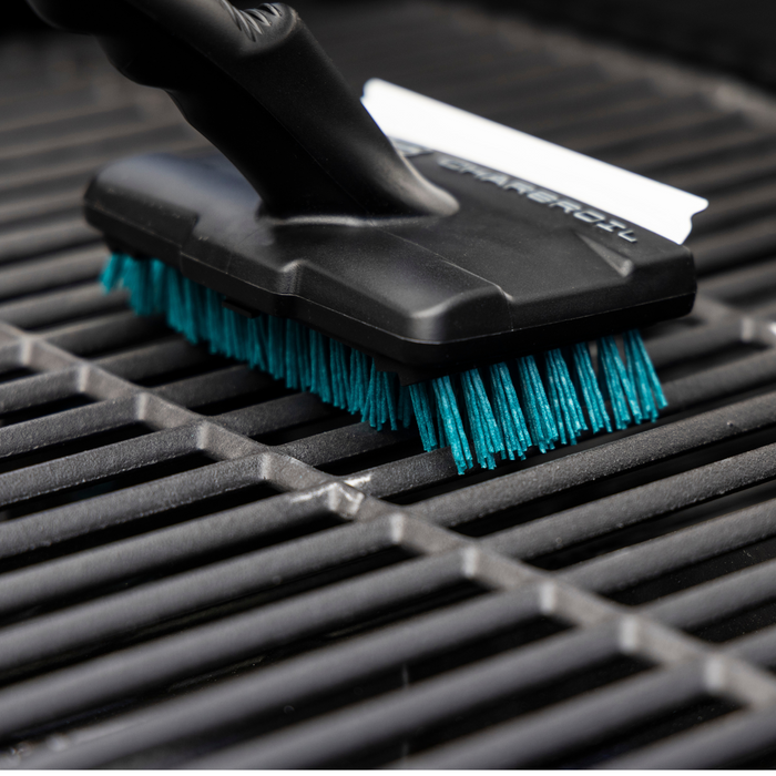 Black and teal brush with "CHARGEOIL" branding on a grill surface.