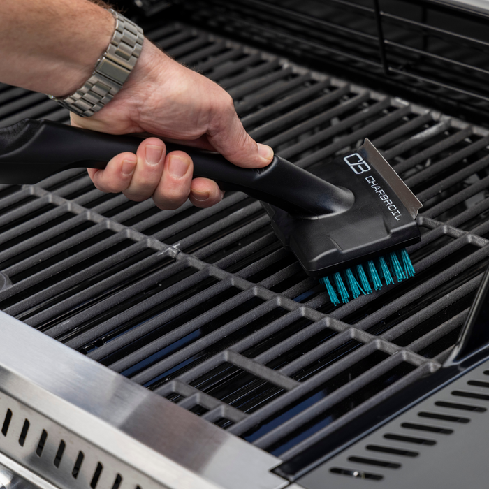 Black Char-Broil grill brush with teal bristles and handle.