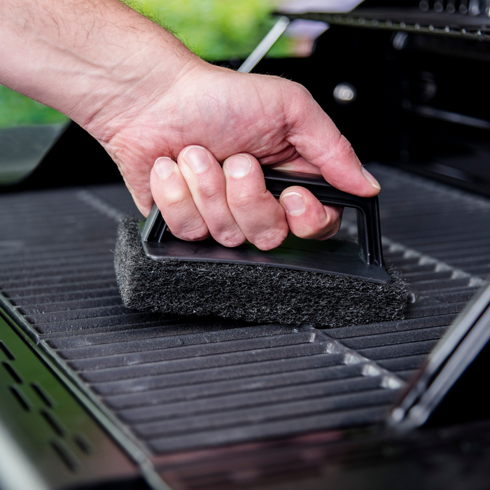 Black grill cleaning brush with handle, designed for easy maintenance.