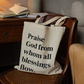 Tote bag with inspirational quote on a chair in a cozy living room setting