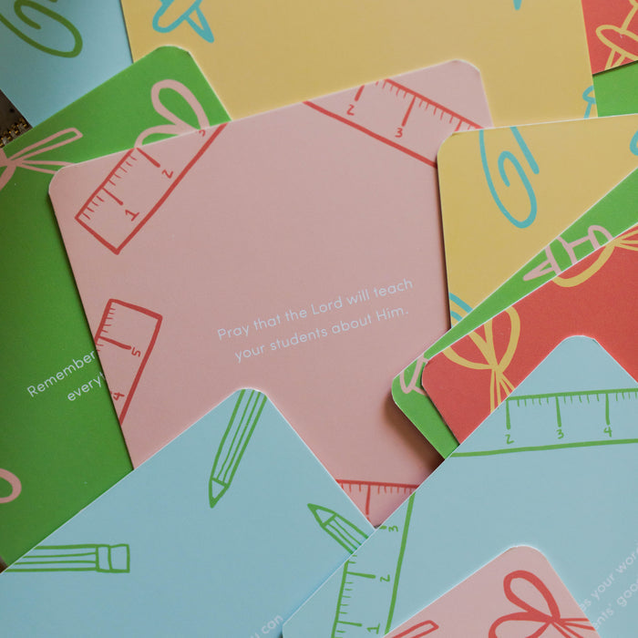 Multiple Colorful Encouragement for Teachers Verse Cards with Rounded Corners laying on a green stripe pencil pouch