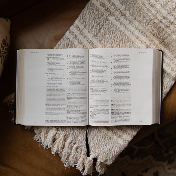 Open bible on a textured blanket