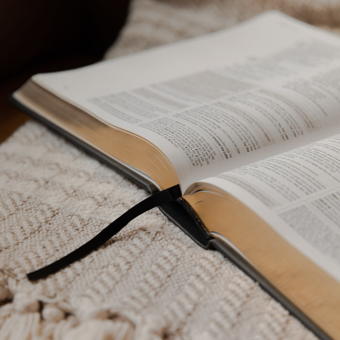 Open bible on a textured surface with a blurred background