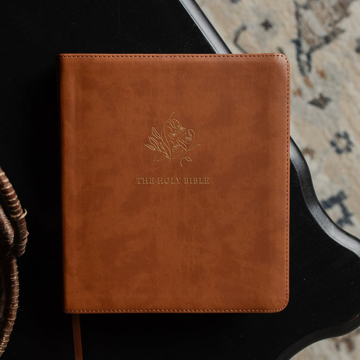A leather ESV bible cover on a dark wooden table