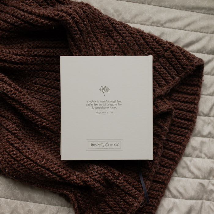 The Back of the ESV Bible Roman cover on a brown blanket