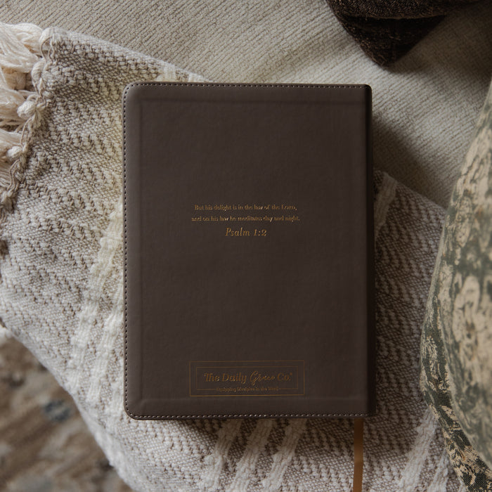 The Holy Bible back cover on a blanket on a couch