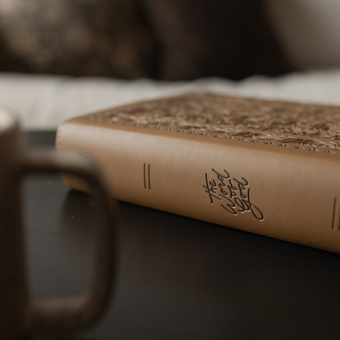 The spine of the ESV Single Column Journaling Bible on a black wooden table