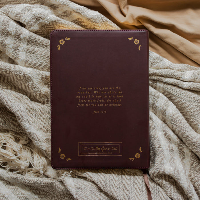 leather bible with gold etching back cover on a textured blanket