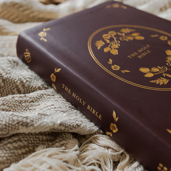 leather bible with gold etching on the spine on a textured blanket