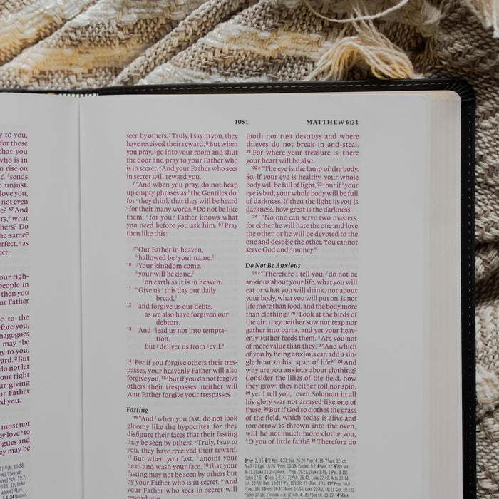 an open bible close up to Matthew 6:31 on a textured blanket