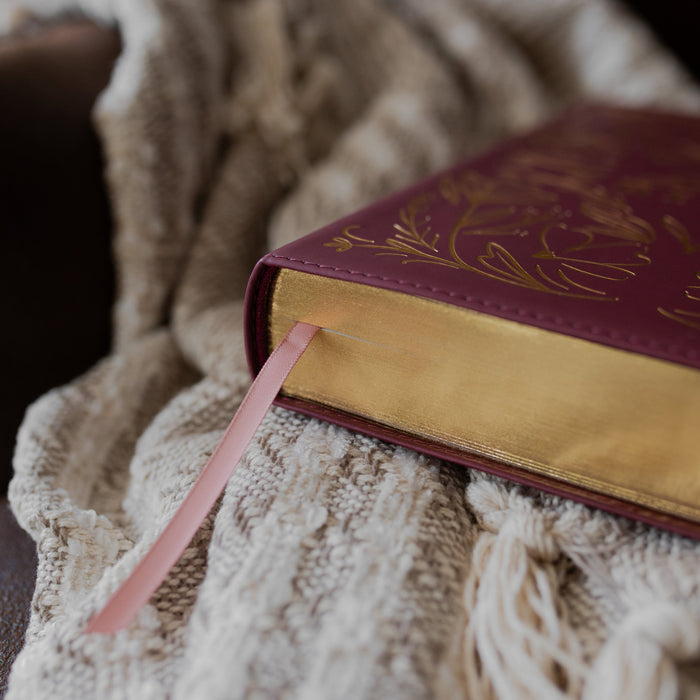 Maroon Bible corner with the tassel sticking out textured blanket