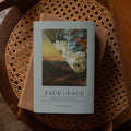 Face to Face Hardcover on a closed bible on a wicker chair