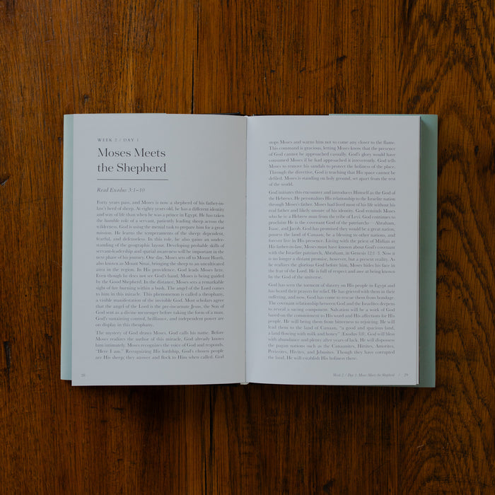 Face to Face Hardcover opened to week 2 day 1 page on a wooden table