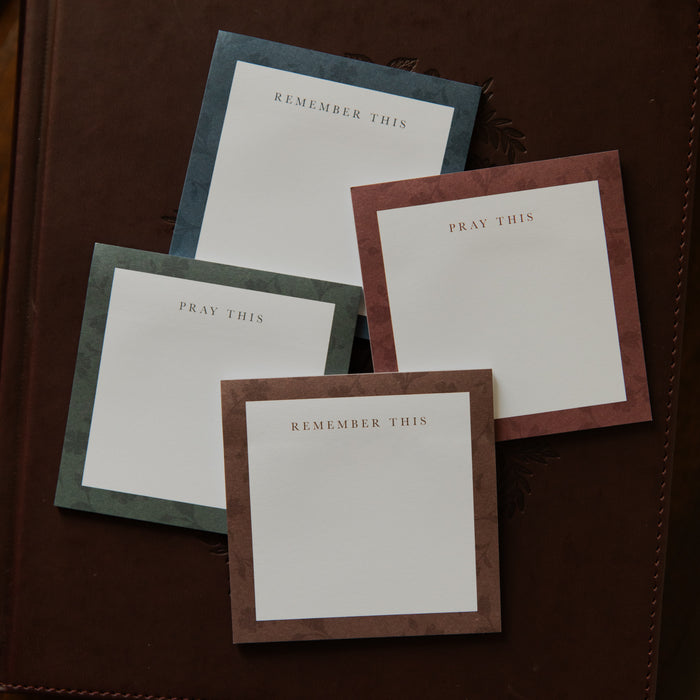 Up close of Four stacks of Floral Border Sticky Notes on a closed bible