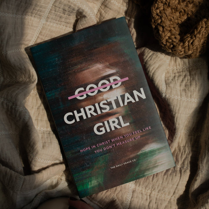 The Good Christian Girl book cover on a tan blanket near a coffee cup