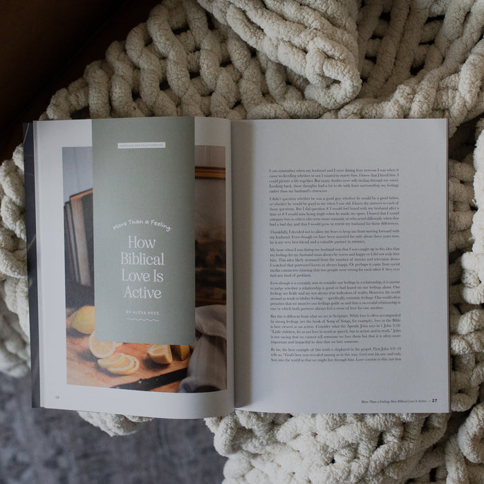 Gospel at Home Issue 7 opened to the devotional page on a white knitted blanket