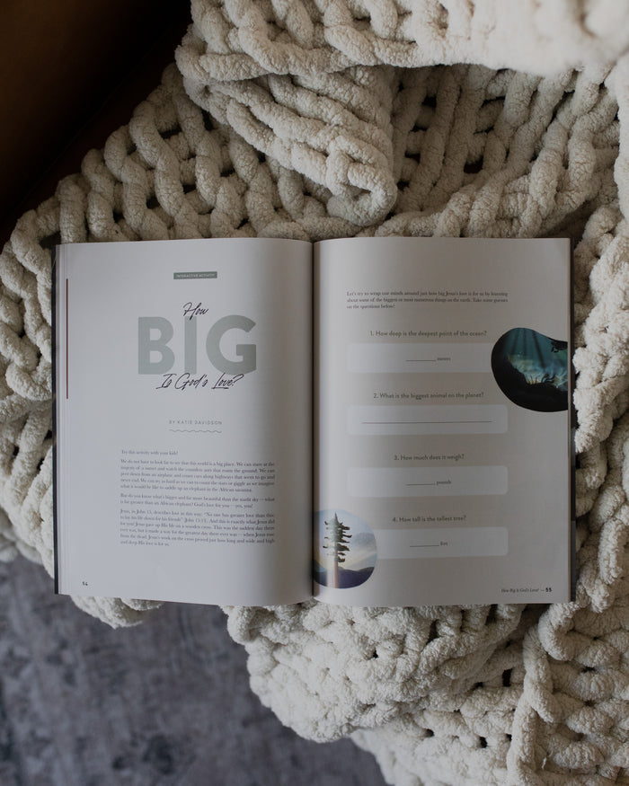Gospel at Home Issue 7 opened to how big is Gods love page on a white knitted blanket
