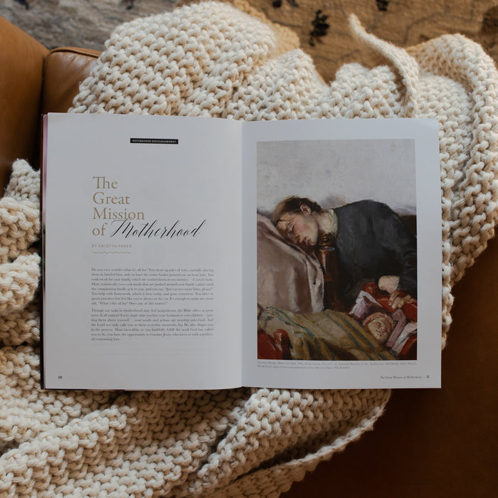 Gospel at Home Issue 11 opened to The Great Mission of Motherhood page on a white knitted blanket