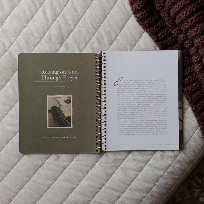 Open book on a textured surface with text and a photo on the left page.