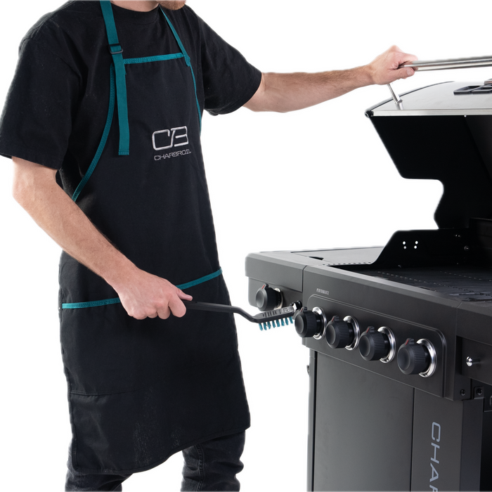 Black Char-Broil Performer gas grill with control knobs and cleaning brush.