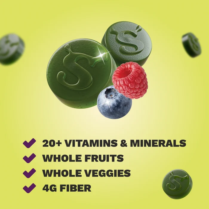 Two green gummies embossed with an S logo, next to a raspberry and blueberry, above a checklist reading 20+ Vitamins & Minerals, Whole Fruits, Whole Veggies, and 4g Fiber, on a yellow-green background.