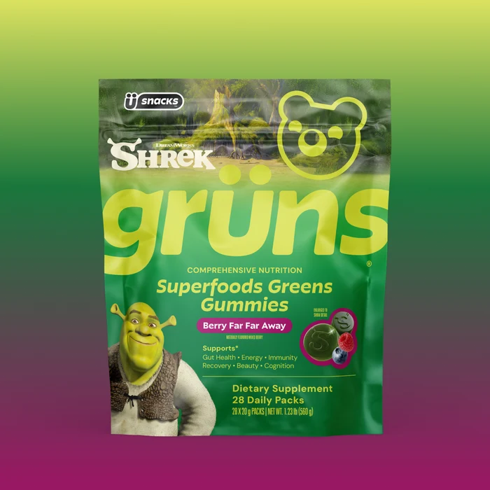 Green Grüns Superfoods Greens Gummies package featuring the Shrek logo and character, labeled Berry Far Far Away flavor, listing support for gut health, energy, immunity, recovery, beauty, and cognition, Dietary Supplement, 28 Daily Packs, on a green-to-purple gradient background.