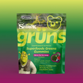 Green Grüns Superfoods Greens Gummies package featuring the Shrek logo and character, labeled Berry Far Far Away flavor, listing support for gut health, energy, immunity, recovery, beauty, and cognition, Dietary Supplement, 28 Daily Packs, on a green-to-purple gradient background.